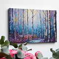 Framed canvas print of a stylised geometric birch forest in vibrant blue, purple, and yellow tones