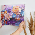 Framed canvas print of vibrant impasto-style abstract flowers in orange, lavender, and blue