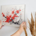 Framed canvas print of abstract ink wash cherry blossoms in vibrant red and black