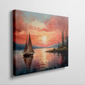 Framed canvas print of a sailboat sailing at sunset with vibrant sky and reflective water