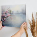 Framed canvas print of impressionist cherry blossoms overlooking a tranquil lake