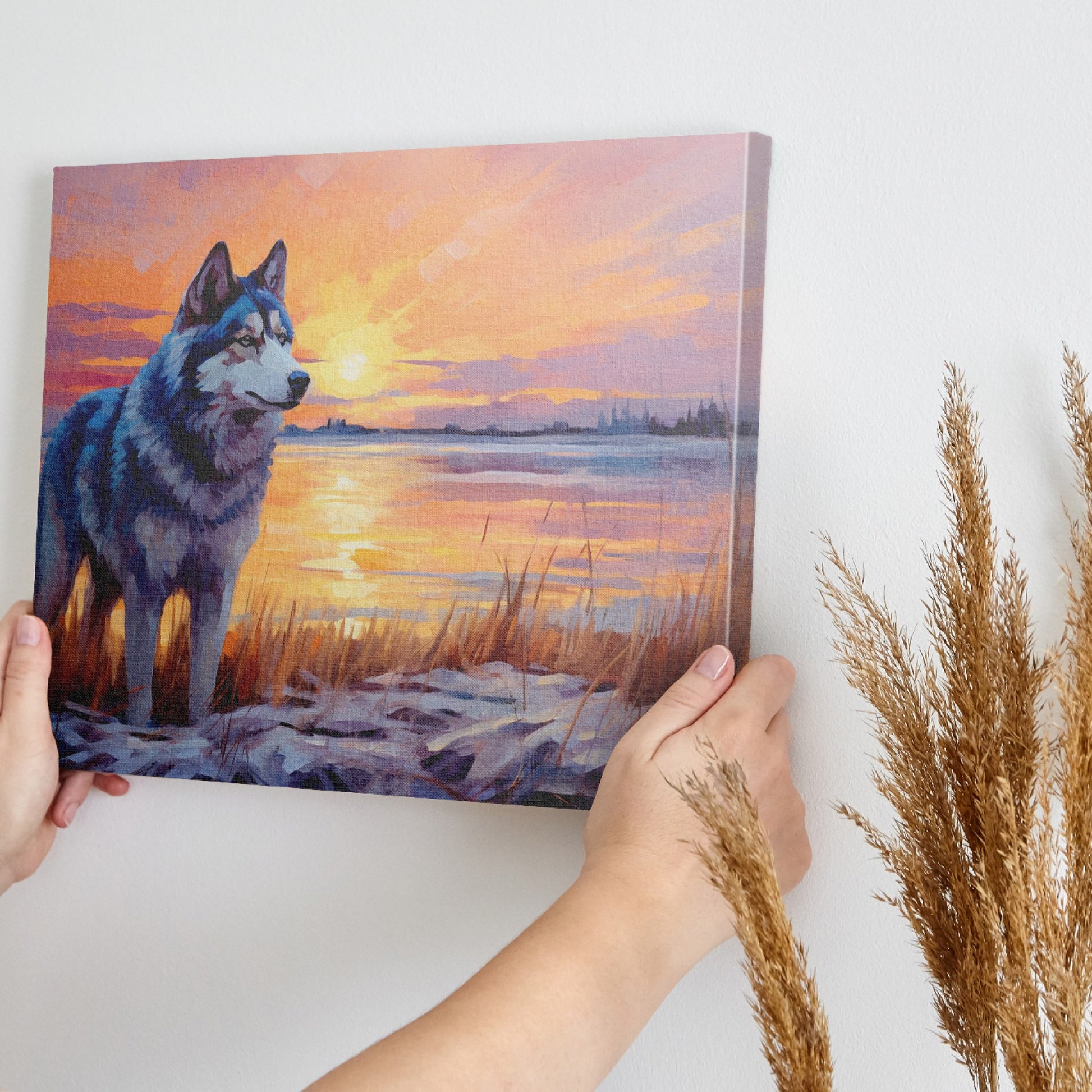 Framed canvas print of a Husky in silhouette against a colourful sunset with reflection on water