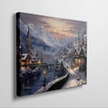 Framed canvas print of a snowy Alpine village at twilight with warm glowing cottages and snow-capped mountains