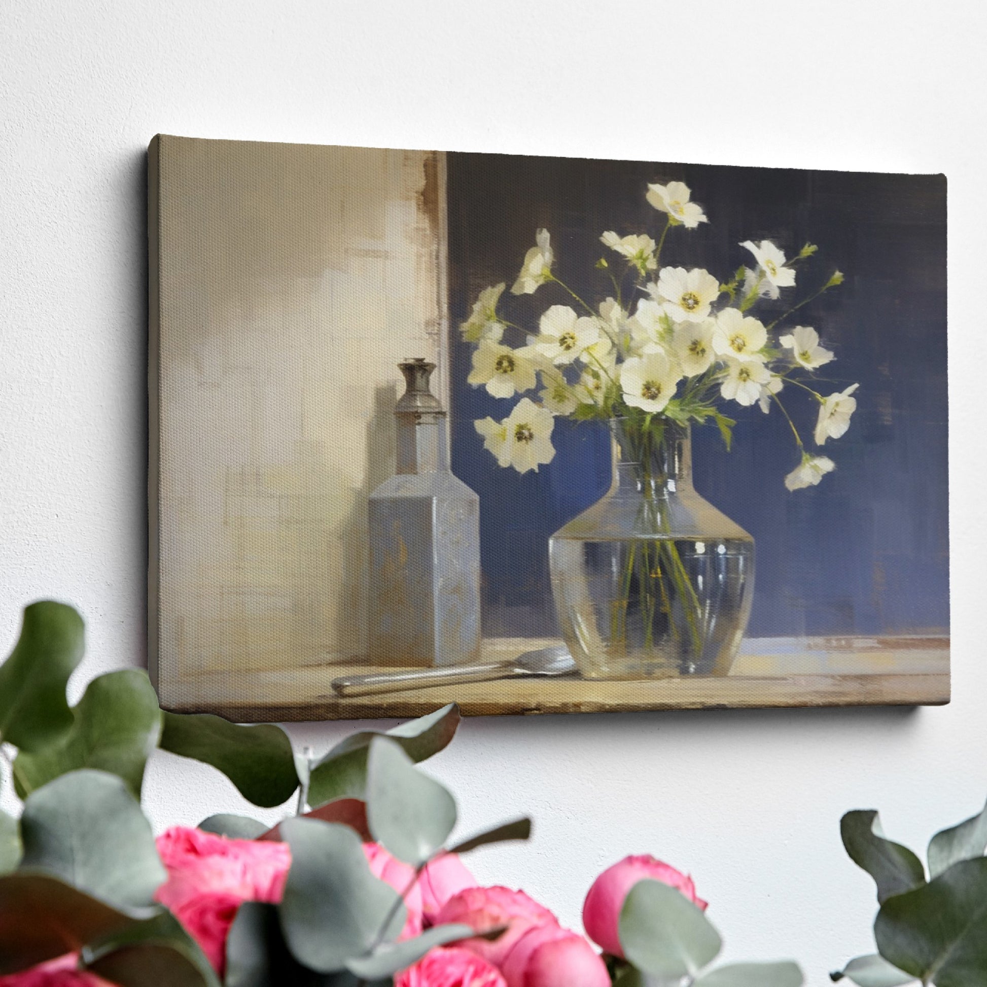 Framed canvas print of white flowers in glass vase with vintage bottle on a neutral background