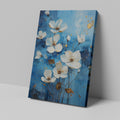 Framed canvas print of contemporary white and gold flowers on a blue background