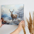 Framed canvas print of a majestic stag in a snowy wilderness, painted in impressionist style with a cool colour palette