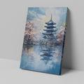 Framed canvas print of a traditional Japanese pagoda and cherry blossoms beside a reflective lake