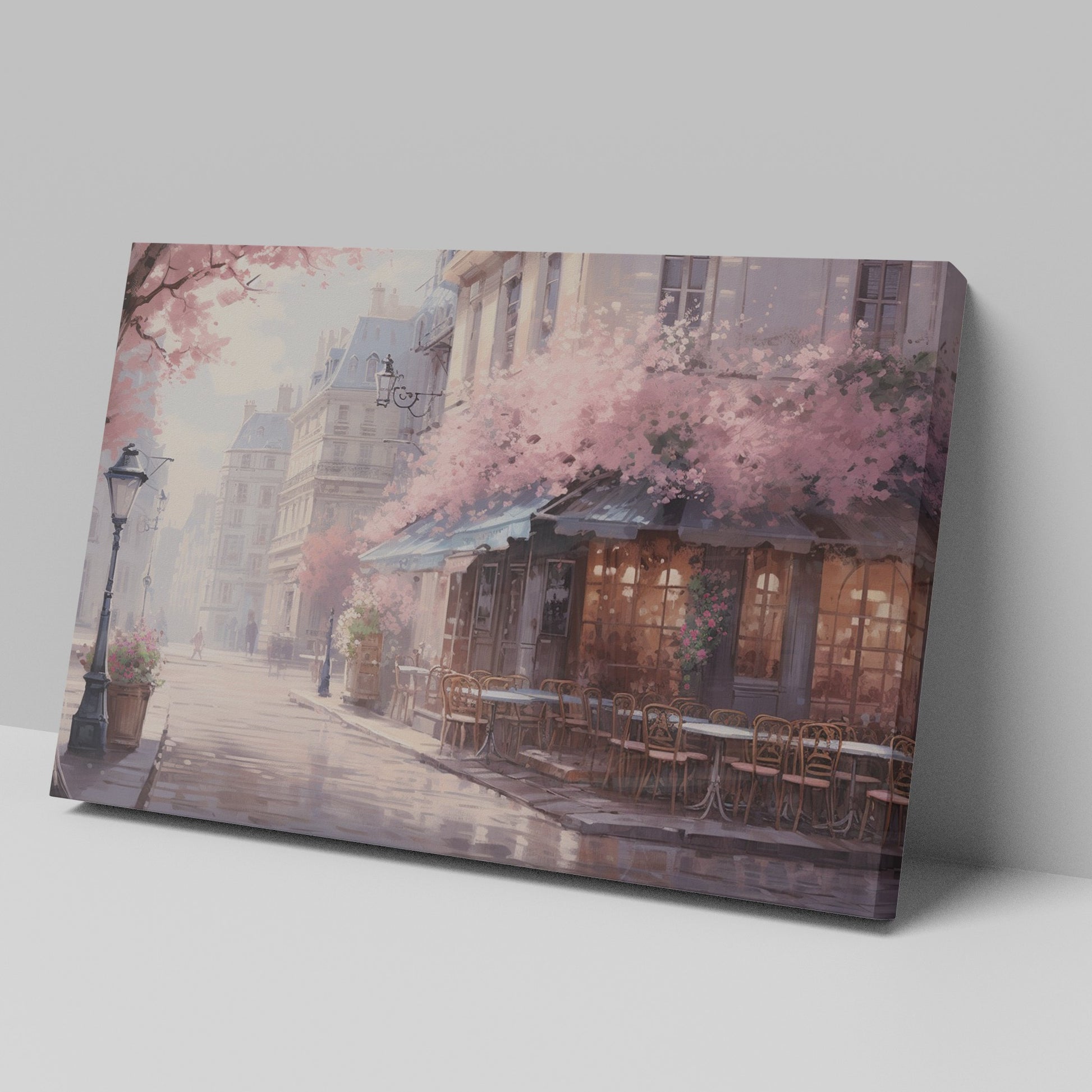 Framed canvas print of a Parisian cafe on a cobblestone street with cherry blossoms in full bloom