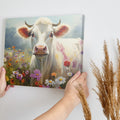 Framed canvas print of a realistic cow in a colourful meadow with wildflowers