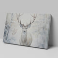 Framed canvas print of a majestic stag set against a snowy forest backdrop with soft beige and white tones