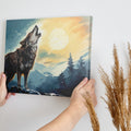 Framed canvas print of a howling wolf in a forest at sunset with orange and blue tones