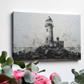 Framed canvas print of a monochrome lighthouse and seagulls on a rocky coastline