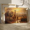 Framed canvas print of a family of giraffes in the savannah during sunset with warm tones