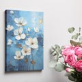 Framed canvas print of contemporary white and gold flowers on a blue background