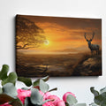 Framed canvas print of a majestic stag in a savanna sunset landscape with warm orange hues