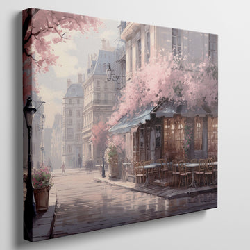 Framed canvas print of a Parisian cafe on a cobblestone street with cherry blossoms in full bloom