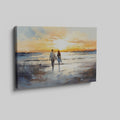 Framed canvas print of a couple walking on the beach at sunset with reflective water and warm colours