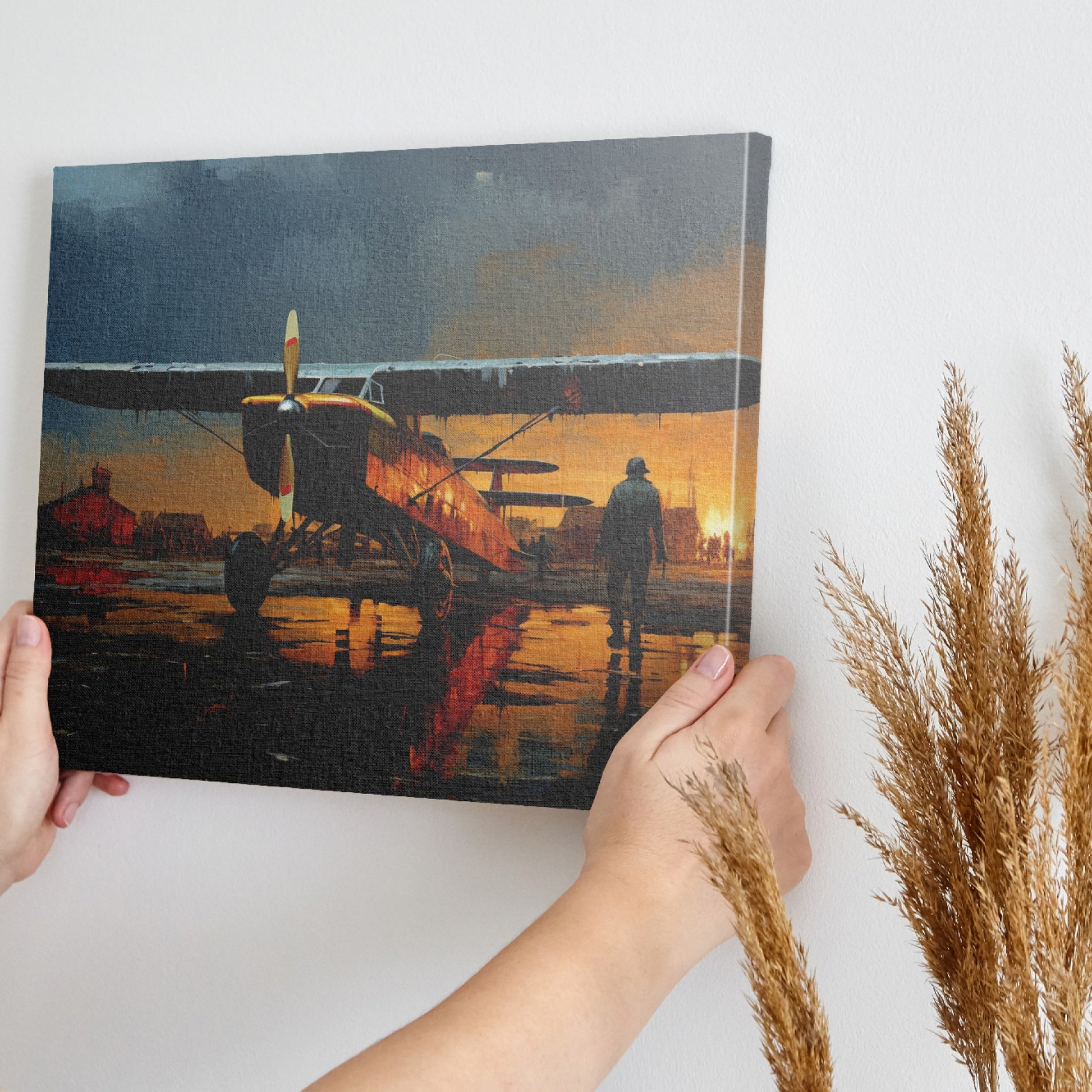 Framed canvas print of a vintage biplane on wet airfield at sunset with pilot walking