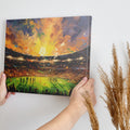 Framed canvas print of an impressionist football stadium with vibrant sunset hues