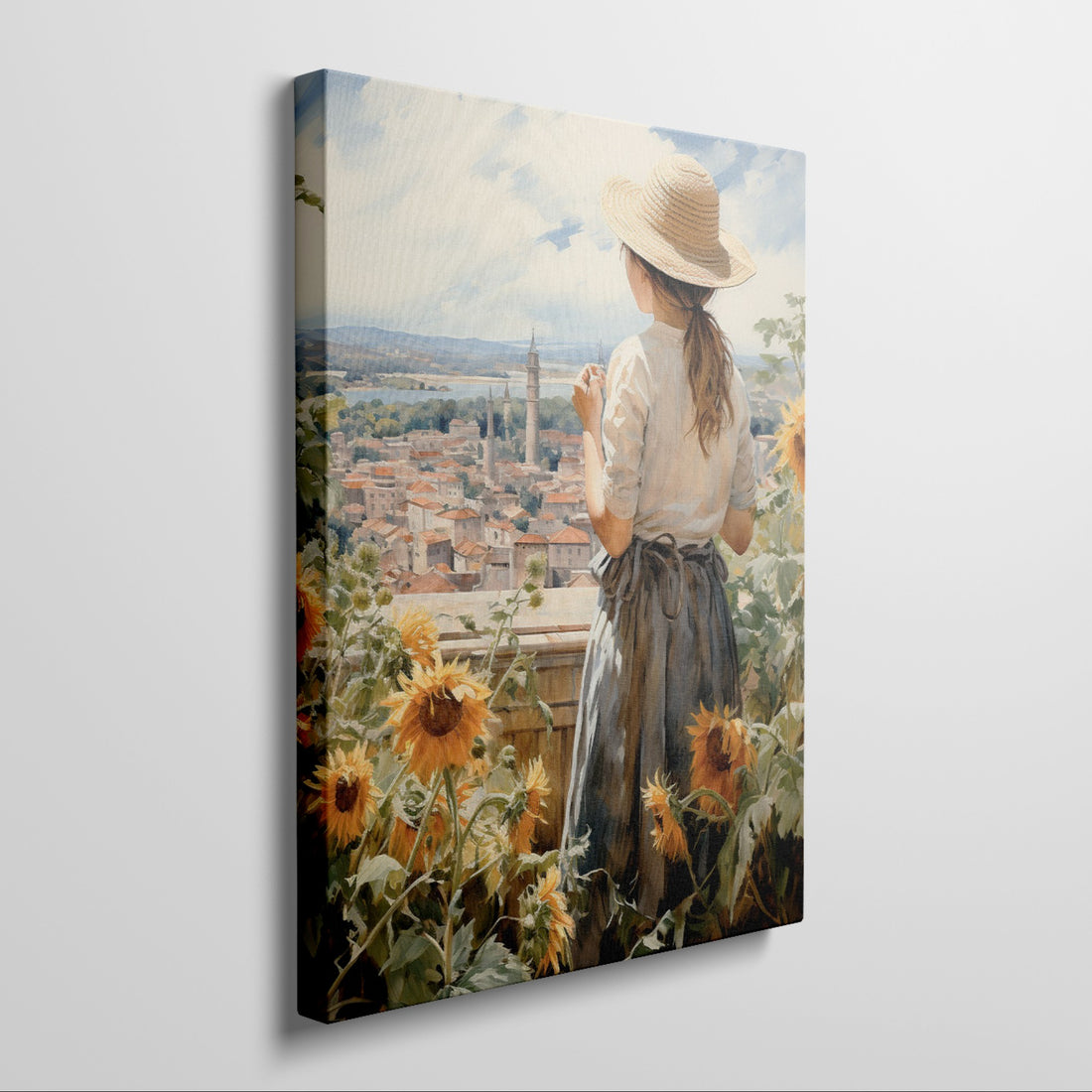 Framed canvas print of a woman gazing over a sunflower field and vintage town