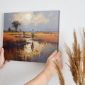 Framed canvas print of a tranquil African savannah landscape with warm sunset and water reflections