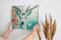 Framed canvas print of a serene stag with vibrant blue and red tones