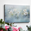 Framed canvas print of serene watercolor flowers with soft blue hues and water reflections