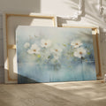 Framed canvas print of serene watercolor flowers with soft blue hues and water reflections