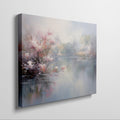 Framed canvas print depicting impressionist art of blossoming trees by a misty lake with soft pastel colours