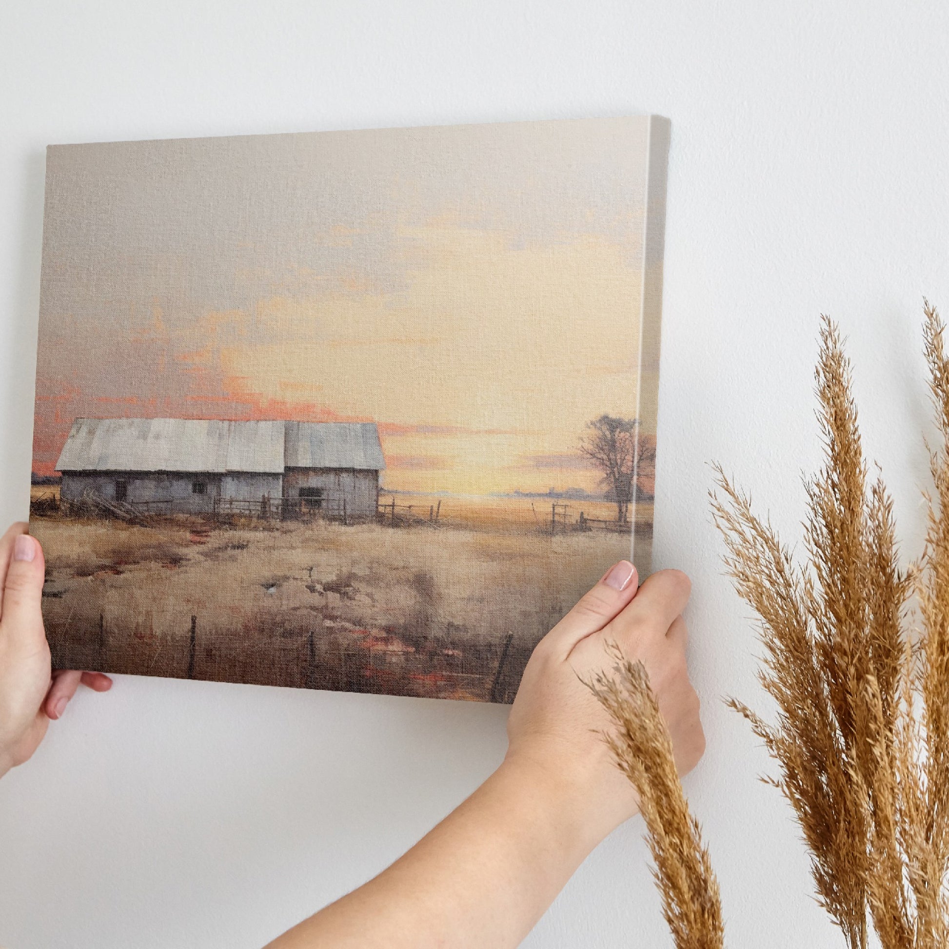 Framed canvas print of a rustic barn surrounded by tranquil fields at sunset, with warm golden and earthy tones.