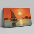 Framed canvas print of a sailboat against an orange sunset with water reflections