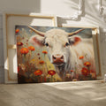 Framed canvas print of realistic cow in a floral setting with warm tones