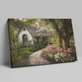 Framed canvas print of a picturesque cottage surrounded by blooming garden and shaded by trees