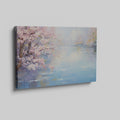 Framed canvas print of a serene impressionist painting with cherry blossoms and river reflections