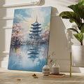 Framed canvas print of a traditional Japanese pagoda and cherry blossoms beside a reflective lake