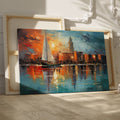 Framed canvas print of an abstract impressionistic sunset marina with a sailing boat and city silhouette