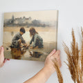 Framed canvas print of two children playing by the shore with a castle in the background