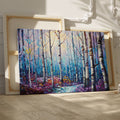 Framed canvas print of a stylised geometric birch forest in vibrant blue, purple, and yellow tones