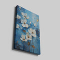 Framed canvas print of contemporary white and gold flowers on a blue background