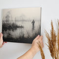 Framed canvas print of a fisherman in a foggy, monochrome lake landscape