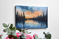 Framed canvas print of a tranquil watercolor landscape depicting a serene lakeside at sunset with reflections of woodland