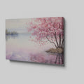 Framed canvas print of a serene cherry blossom tree by a quiet lake with pink and purple reflections