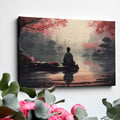 Framed canvas print of a serene digital painting with a figure sitting near water, reflecting cherry blossoms and a city silhouette