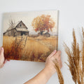 Framed canvas print of a rustic barn in autumn with golden fields and a leafy tree