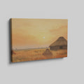 Framed canvas print of a rustic thatched cottage in a countryside landscape at sunset with warm golden and orange hues