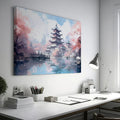 Framed canvas print of a Japanese pagoda surrounded by cherry blossoms and reflected in a tranquil pond