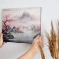 Framed canvas print of a traditional Asian landscape with cherry blossoms and misty mountains