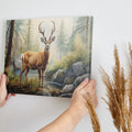 Framed canvas print of realistic deer in a forest with a stream and rocks