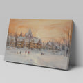 Framed canvas print of a snowy Victorian village at sunset with people ice skating