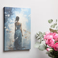 Framed canvas print of a woman in a teal dress with abstract floral background